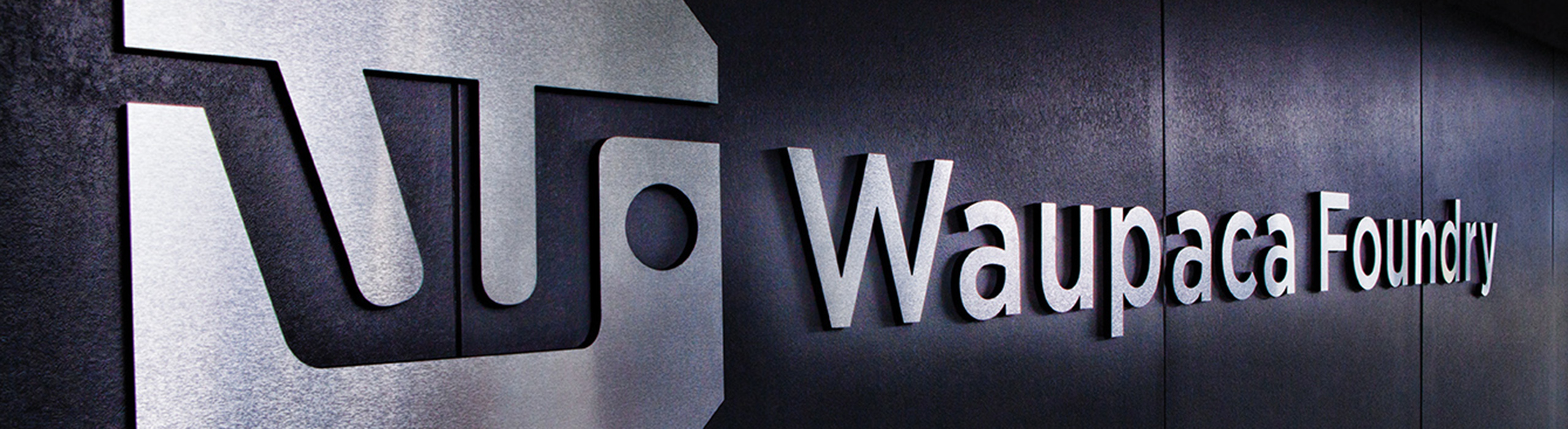 Waupaca Foundry logo on wall